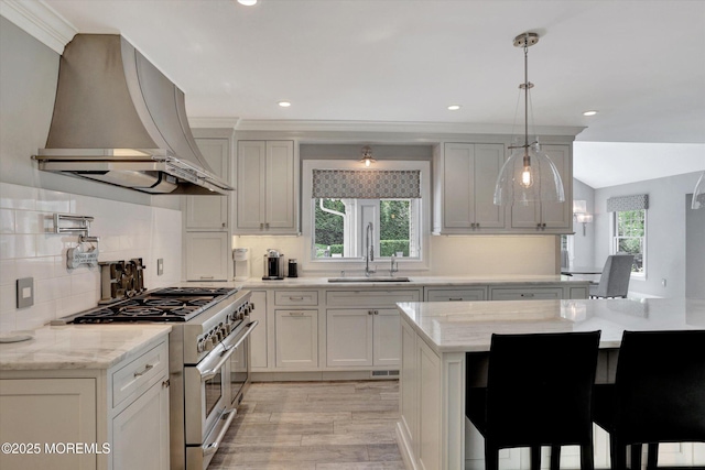 12 Wagon Way, Holmdel, NJ 07733 - kitchen with range hood, stainless steel range, a sink, decorative backsplash, and light wood finished floors