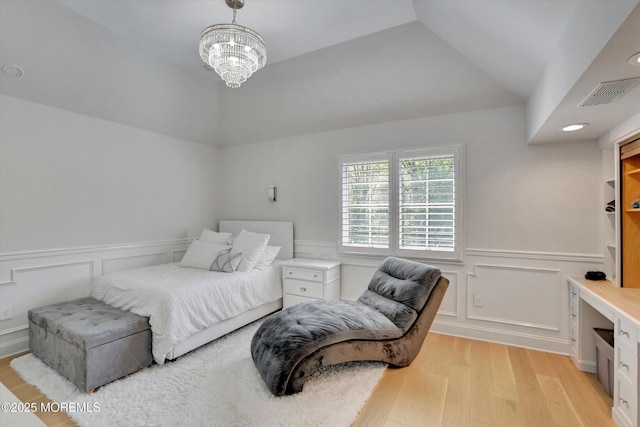 12 Wagon Way, Holmdel, NJ 07733 - bedroom featuring light wood-style floors, a chandelier, a wainscoted wall, a decorative wall, and lofted ceiling