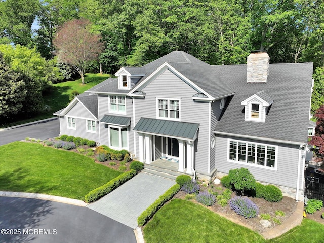 12 Wagon Way, Holmdel, NJ 07733 - shingle-style home featuring a standing seam roof, a front yard, roof with shingles, metal roof, and a chimney