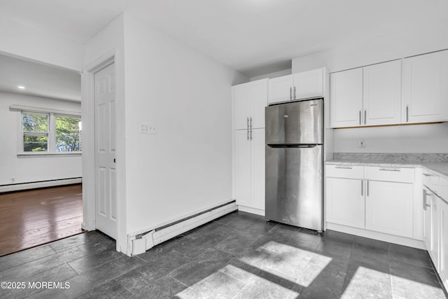 1324 Sixth Ave, Toms River, NJ 08757 - kitchen with freestanding refrigerator, a baseboard radiator, white cabinetry, and light stone counters