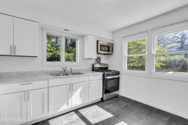 1324 Sixth Ave, Toms River, NJ 08757 - kitchen featuring appliances with stainless steel finishes, a sink, baseboards, and white cabinetry