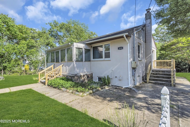 1324 Sixth Ave, Toms River, NJ 08757 - view of front of house with a chimney, a front yard, and stucco siding