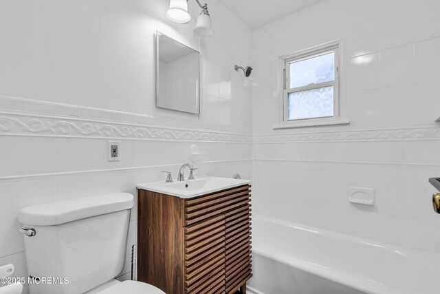 1324 Sixth Ave, Toms River, NJ 08757 - bathroom with toilet, tile walls,  shower combination, vanity, and wainscoting