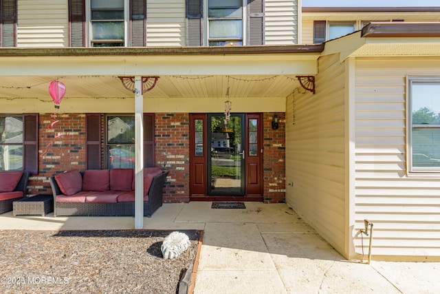 16 Markwood Dr, Howell, NJ 07731 - doorway to property with brick siding, covered porch, and outdoor lounge area