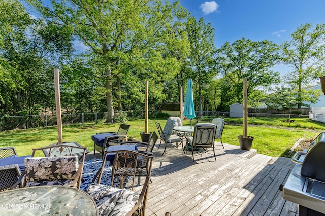 16 Markwood Dr, Howell, NJ 07731 - deck with outdoor dining space, view of scattered trees, a storage unit, and an outdoor living space with a fire pit