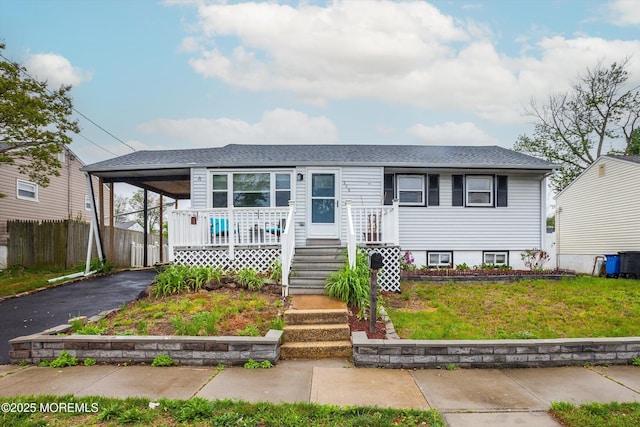206 Arlington Ave, Union Beach, NJ 07735 - view of front facade featuring an attached carport, driveway, a shingled roof, and covered porch