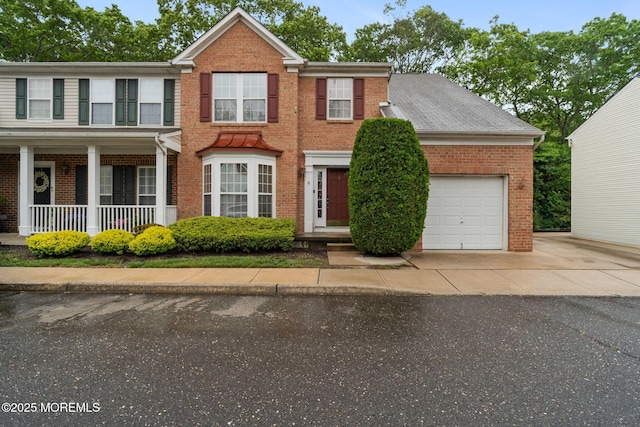 6 Foxmoor Ln, Bayville, NJ 08721 - view of front of home featuring brick siding, a garage, concrete driveway, and covered porch