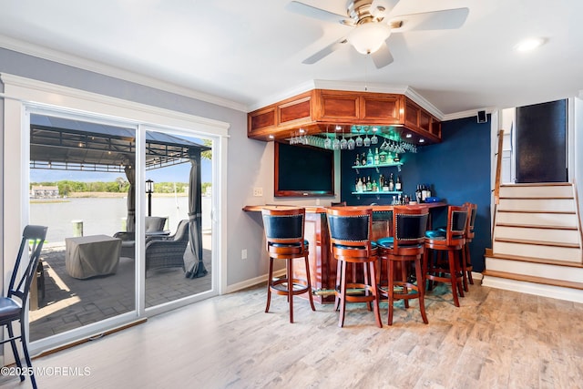 660 Fairview Ln, Forked River, NJ 08731 - indoor dry bar featuring a ceiling fan, light wood-style floors, crown molding, baseboards, and stairway