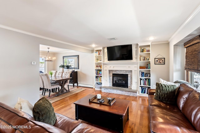 660 Fairview Ln, Forked River, NJ 08731 - living room with light wood-style flooring, a chandelier, ornamental molding, a fireplace, and a baseboard radiator