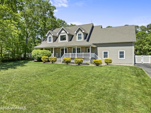 274 Beachview Ave, Manahawkin, NJ 08050 - cape cod-style house with a porch, a gate, a shingled roof, and a front lawn