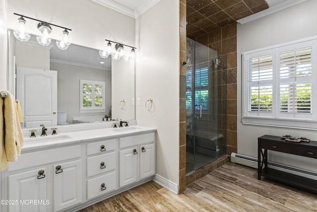 274 Beachview Ave, Manahawkin, NJ 08050 - bathroom with double vanity, a stall shower, ornamental molding, wood finished floors, and baseboards