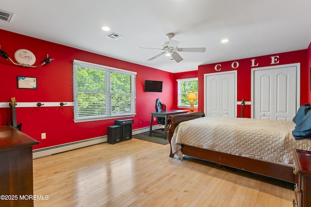 274 Beachview Ave, Manahawkin, NJ 08050 - bedroom with baseboard heating, two closets, hardwood / wood-style floors, recessed lighting, and ceiling fan