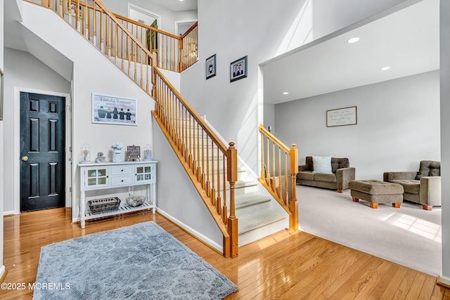 707 Cedar Point Ct, Toms River, NJ 08753 - staircase with hardwood / wood-style flooring, a towering ceiling, recessed lighting, and baseboards