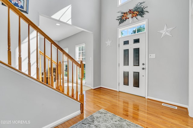 707 Cedar Point Ct, Toms River, NJ 08753 - foyer entrance with a high ceiling, stairs, wood finished floors, and baseboards
