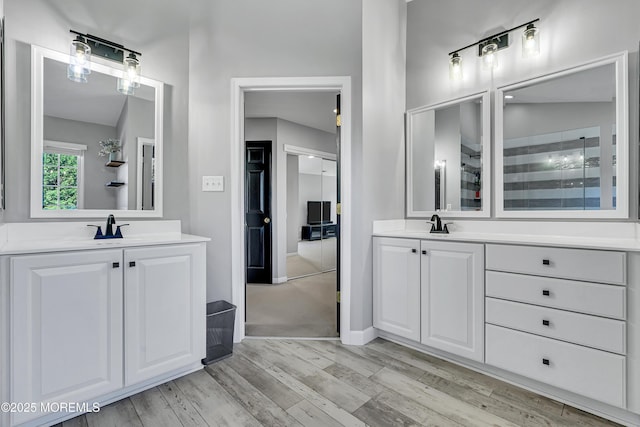 707 Cedar Point Ct, Toms River, NJ 08753 - bathroom featuring two vanities, wood finished floors, baseboards, and a tile shower