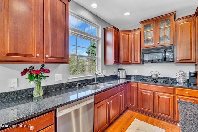 707 Cedar Point Ct, Toms River, NJ 08753 - kitchen with black appliances, a sink, light wood-type flooring, dark stone counters, and recessed lighting