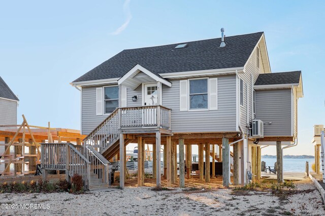 151 Shore Dr, Brick, NJ 08723 - rear view of house with a carport, roof with shingles, a water view, and ac unit