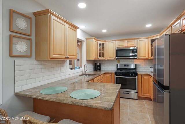 151 Shore Dr, Brick, NJ 08723 - kitchen with stainless steel appliances, a sink, a peninsula, tasteful backsplash, and light stone counters