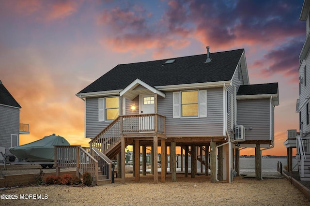 151 Shore Dr, Brick, NJ 08723 - back of property with a carport, a shingled roof, and stairs