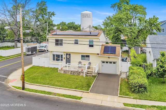 39 Scholer Dr, Union Beach, NJ 07735 - view of front of house featuring roof mounted solar panels, a gate, and concrete driveway