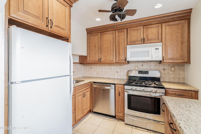 39 Scholer Dr, Union Beach, NJ 07735 - kitchen with stainless steel appliances, tasteful backsplash, recessed lighting, ceiling fan, and light tile patterned floors