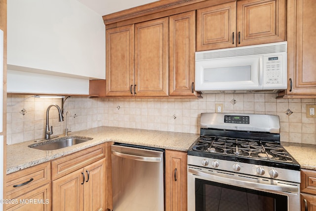 39 Scholer Dr, Union Beach, NJ 07735 - kitchen featuring stainless steel appliances, a sink, tasteful backsplash, and light stone counters