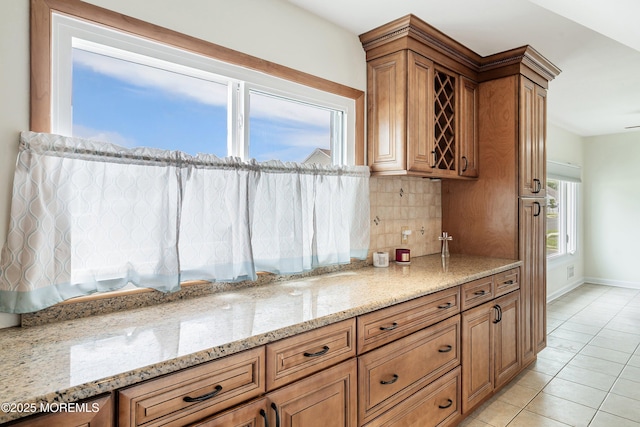 39 Scholer Dr, Union Beach, NJ 07735 - kitchen featuring backsplash, light stone countertops, brown cabinetry, and baseboards