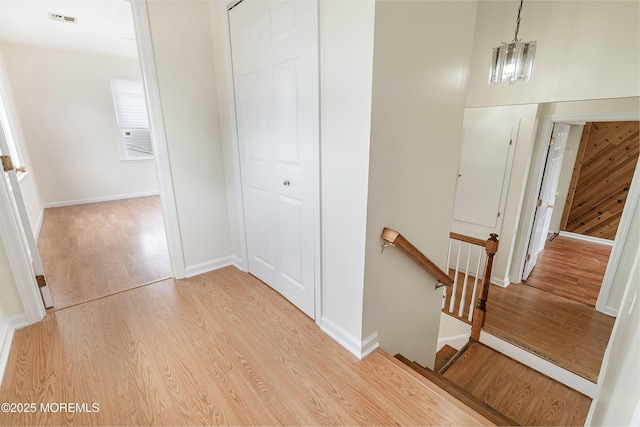 39 Scholer Dr, Union Beach, NJ 07735 - hall featuring an upstairs landing, light wood finished floors, baseboards, and a chandelier
