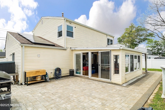 39 Scholer Dr, Union Beach, NJ 07735 - back of house with solar panels, a sunroom, a patio, and central AC unit