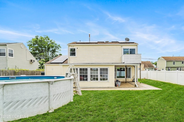 39 Scholer Dr, Union Beach, NJ 07735 - rear view of house featuring solar panels and a patio area