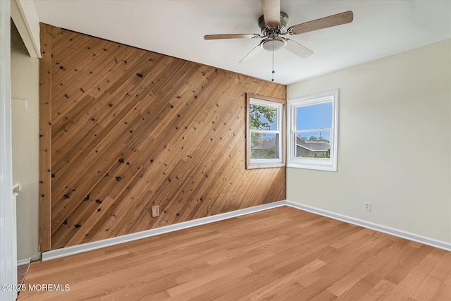 39 Scholer Dr, Union Beach, NJ 07735 - empty room featuring baseboards, ceiling fan, light wood-type flooring, and wood walls
