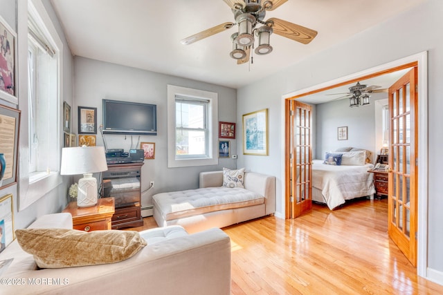 1707-1705 N Bayview Ave, Seaside Park, NJ 08752 - living room with a ceiling fan, wood finished floors, baseboard heating, and baseboards