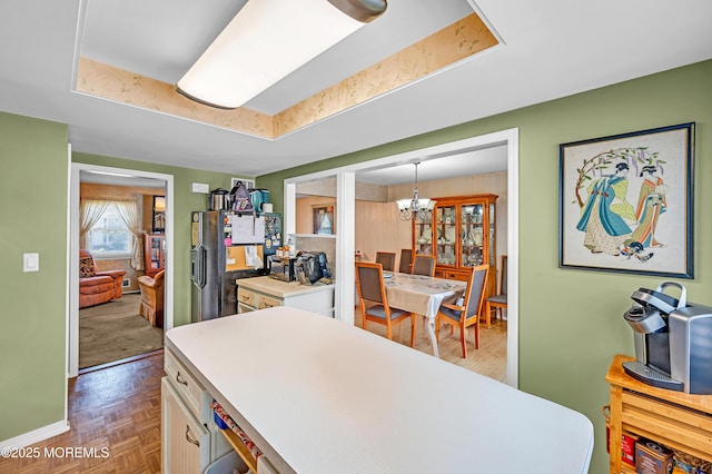 14 N Longview Rd, Howell, NJ 07731 - kitchen featuring a chandelier, light countertops, baseboards, black fridge with ice dispenser, and a tray ceiling