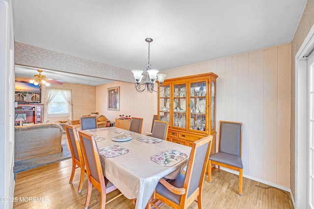 14 N Longview Rd, Howell, NJ 07731 - dining space with a chandelier, light wood-style floors, wooden walls, and a ceiling fan