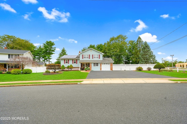 14 N Longview Rd, Howell, NJ 07731 - view of front of house with asphalt driveway, solar panels, and an attached garage
