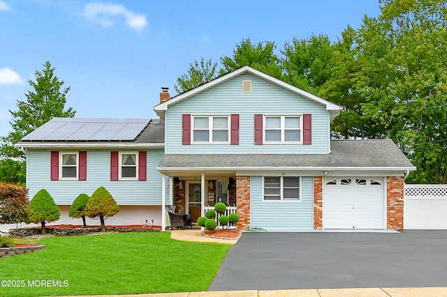 14 N Longview Rd, Howell, NJ 07731 - split level home featuring covered porch, driveway, an attached garage, roof mounted solar panels, and a chimney
