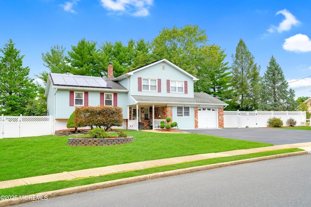 14 N Longview Rd, Howell, NJ 07731 - tri-level home featuring a porch, solar panels, driveway, a garage, and a chimney