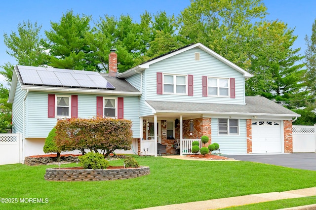 14 N Longview Rd, Howell, NJ 07731 - tri-level home with a porch, a garage, solar panels, a chimney, and asphalt driveway