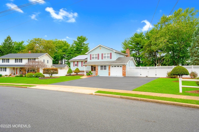 14 N Longview Rd, Howell, NJ 07731 - view of front facade with asphalt driveway and a gate