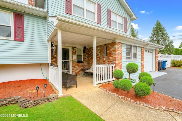 14 N Longview Rd, Howell, NJ 07731 - view of exterior entry with covered porch, brick siding, and driveway
