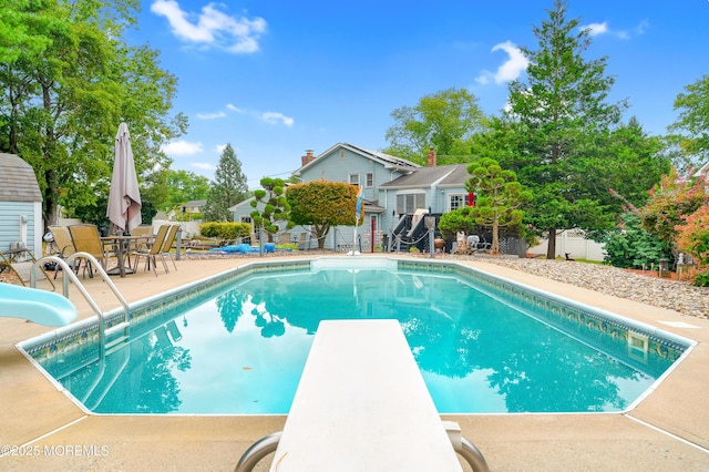 14 N Longview Rd, Howell, NJ 07731 - view of swimming pool featuring a diving board, a water slide, a fenced backyard, and a patio