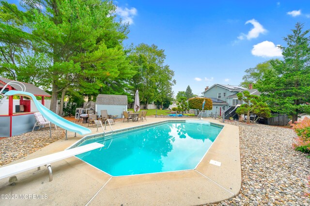 14 N Longview Rd, Howell, NJ 07731 - swimming pool featuring a diving board, a water slide, a playground, and a patio area