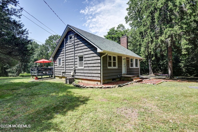 2897 State Route 138, Wall, NJ 07719 - view of property exterior with a chimney, a yard, and a shingled roof