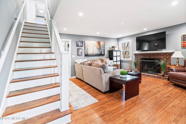 2897 State Route 138, Wall, NJ 07719 - living room featuring stairway, light wood-style flooring, recessed lighting, and a brick fireplace