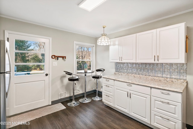 2897 State Route 138, Wall, NJ 07719 - kitchen featuring freestanding refrigerator, dark wood finished floors, white cabinetry, backsplash, and ornamental molding