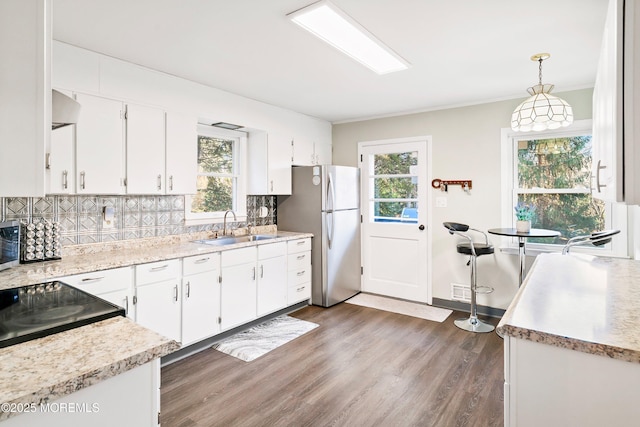 2897 State Route 138, Wall, NJ 07719 - kitchen with appliances with stainless steel finishes, a sink, backsplash, light countertops, and white cabinetry