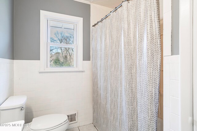 2897 State Route 138, Wall, NJ 07719 - full bathroom with tile walls, toilet, a wainscoted wall, and a shower with curtain