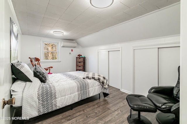 2897 State Route 138, Wall, NJ 07719 - bedroom with an AC wall unit, multiple closets, wood finished floors, and lofted ceiling