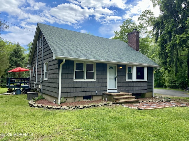 2897 State Route 138, Wall, NJ 07719 - view of front of home featuring a shingled roof, a chimney, and a front lawn