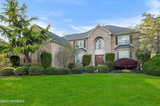 10 Emma Ln, Jackson, NJ 08527 - traditional-style house featuring a front yard, brick siding, and roof with shingles